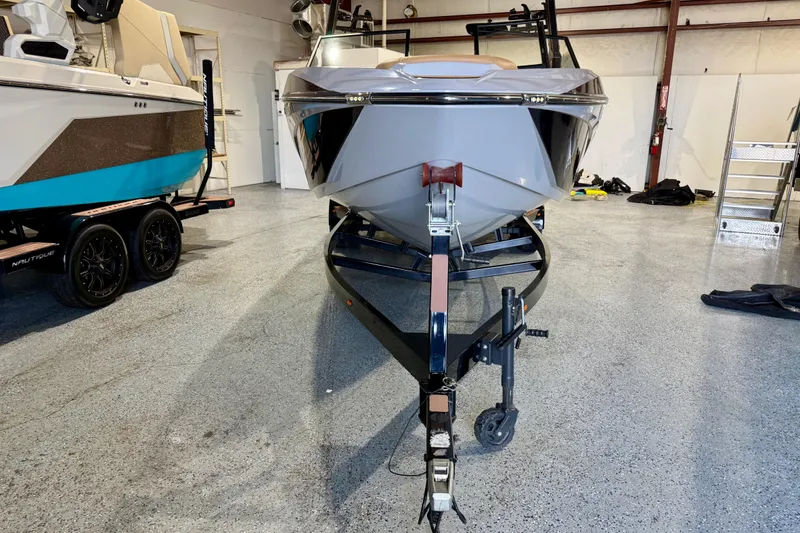Slide: The Image of 2023 Tigé Z5 boat on trailer in a showroom, front view. - 9