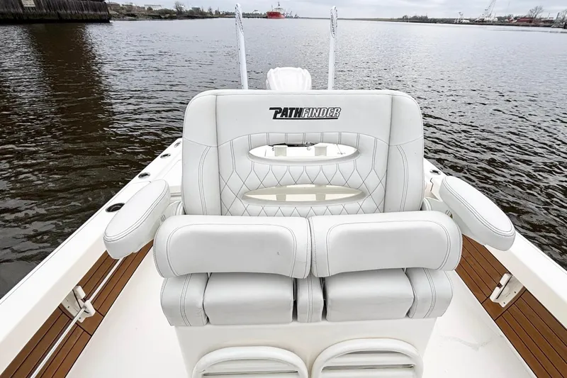 Slide: The Image of 2023 Pathfinder 2500 Hybrid boat with luxurious seating on calm water. - 13