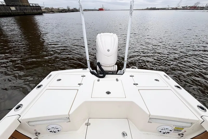 Slide: The Image of 2023 Pathfinder 2500 Hybrid boat on water, showcasing rear deck and motor. - 18