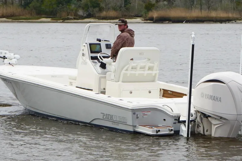 Slide: The Image of 2023 Pathfinder 2500 Hybrid boat with Yamaha engine on a calm river. - 3