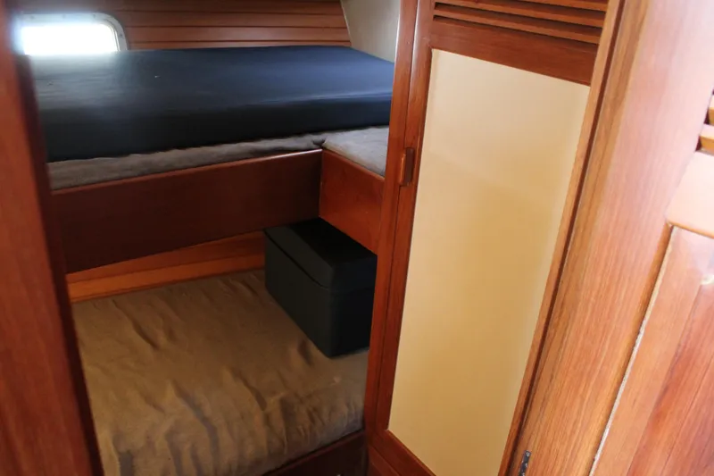 Slide: The Image of 1985 Ventura South Bay Flybridge Sedan Sport cabin interior with wooden bunk beds. - 10