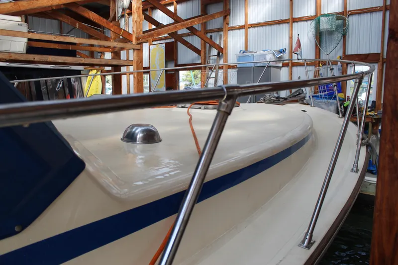 Slide: The Image of 1985 Ventura South Bay Flybridge Sedan Sport boat in a wooden dock. - 19