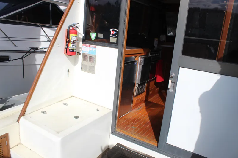 Slide: The Image of 1985 Ventura South Bay Flybridge Sedan Sport yacht interior with kitchen and fire extinguisher. - 21
