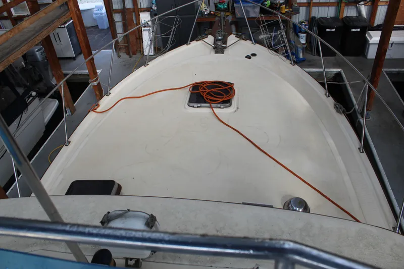 Slide: The Image of 1985 Ventura South Bay Flybridge Sedan Sport boat deck in a storage facility. - 22