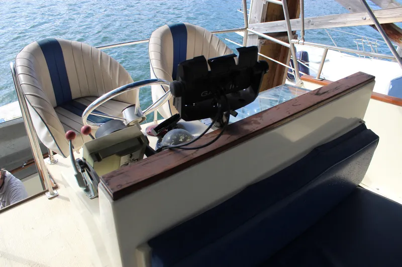 Slide: The Image of 1985 Ventura South Bay Flybridge Sedan Sport helm with dual seats and steering wheel. - 23