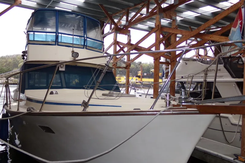 Slide: The Image of 1985 Ventura South Bay Flybridge Sedan Sport boat docked in a marina. - 3