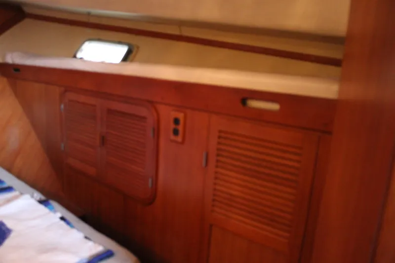 Slide: The Image of 1985 Ventura South Bay Flybridge Sedan Sport interior with wooden cabinetry and small window. - 6
