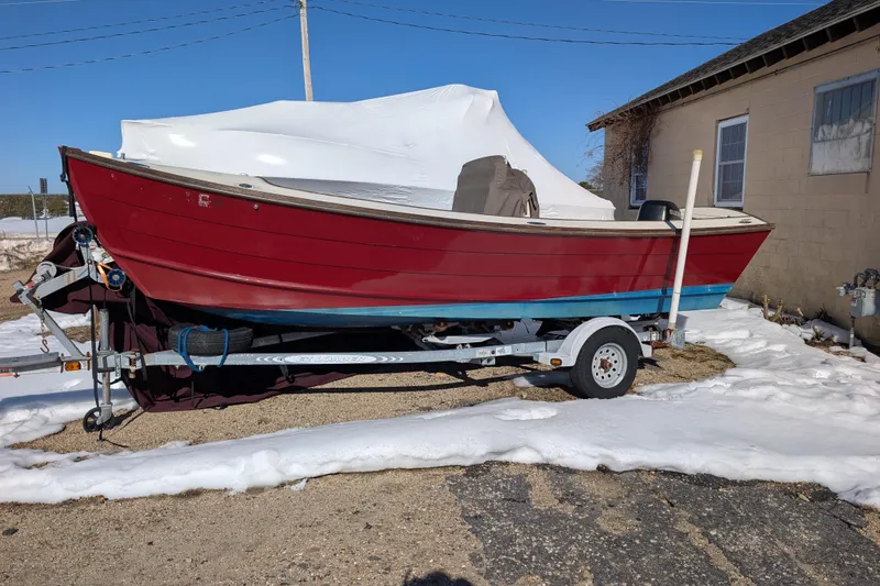 The Image of Red 1998 Belkov skiff boat on trailer, parked on snowy ground. - 0