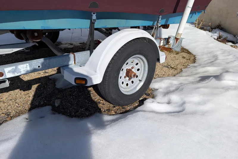 Slide: The Image of Trailer wheel of a 1998 Belkov skiff on snowy ground. - 11