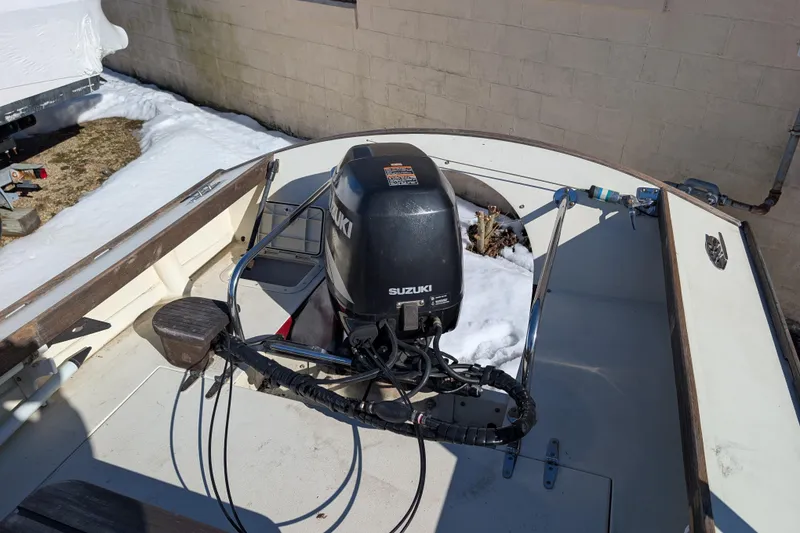 Slide: The Image of 1998 Belkov skiff with Suzuki outboard motor, parked on snow-covered ground. - 12