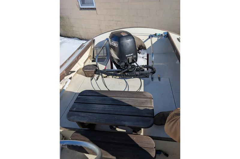 Slide: The Image of 1998 Belkov skiff with Suzuki outboard motor, featuring wooden seating and a clean deck. - 14