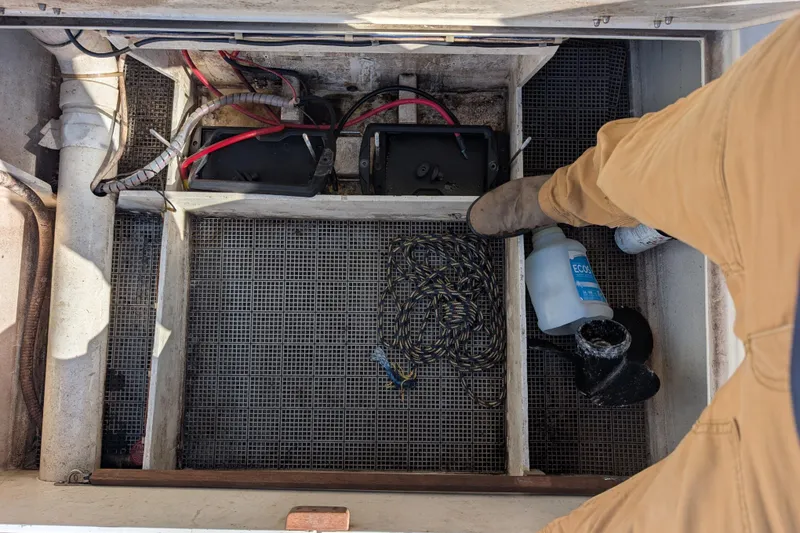 Slide: The Image of Interior of a 1998 Belkov skiff showing battery compartment and maintenance supplies. - 15