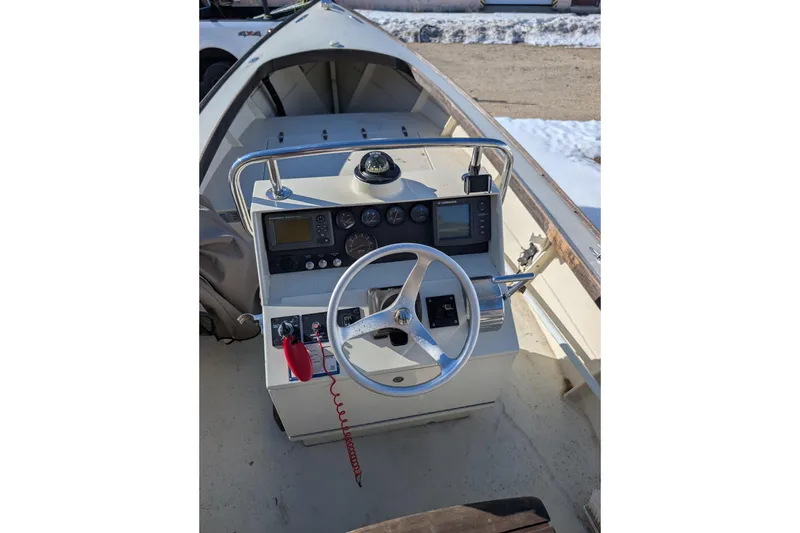 Slide: The Image of 1998 Belkov skiff boat dashboard with steering wheel and navigation instruments. - 3