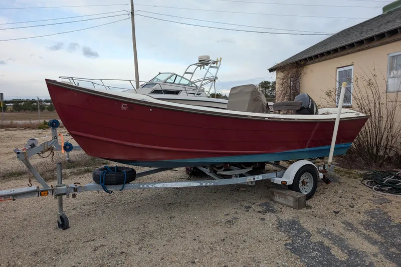 Slide: The Image of 1998 Belkov skiff boat on trailer, parked outdoors near a building. - 37
