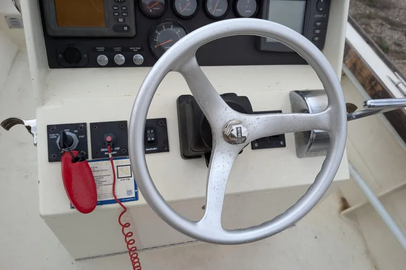 Slide: The Image of Steering wheel and controls of a 1998 Belkov skiff boat. - 4