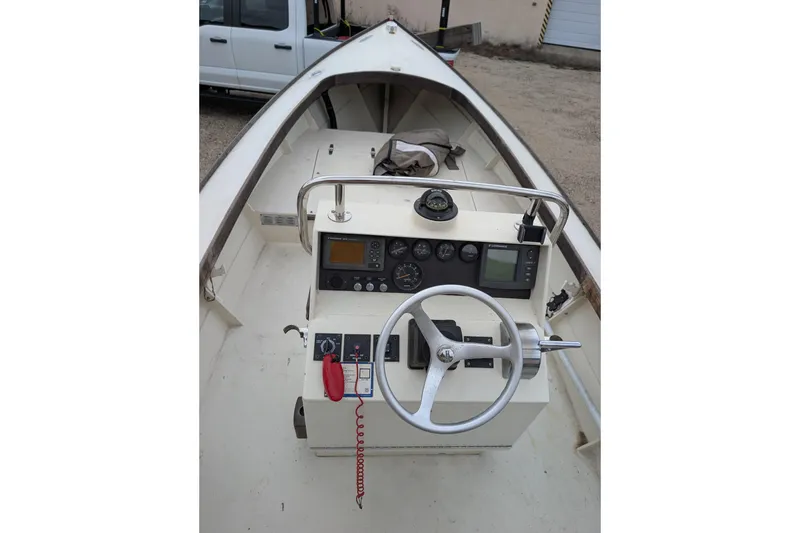 Slide: The Image of 1998 Belkov skiff boat interior with steering wheel and control panel. - 5