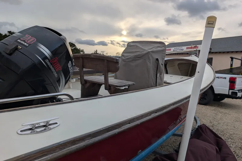 Slide: The Image of 1998 Belkov skiff with Suzuki engine at Harden's Boatyard, sunset in background. - 8