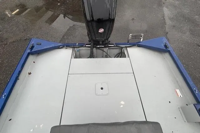 Slide: The Image of 2024 Lund 2070 Predator CC boat, rear view, showcasing spacious deck and motor. - 7