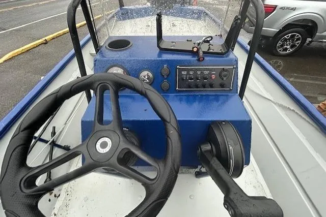 Slide: The Image of 2024 Lund 2070 Predator CC boat console with steering wheel and control panel. - 9