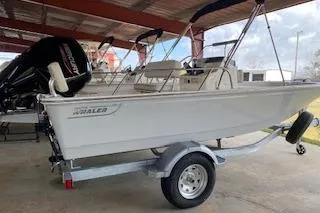 The Image of 2026 Boston Whaler 170 Montauk boat on trailer under shelter. - 0