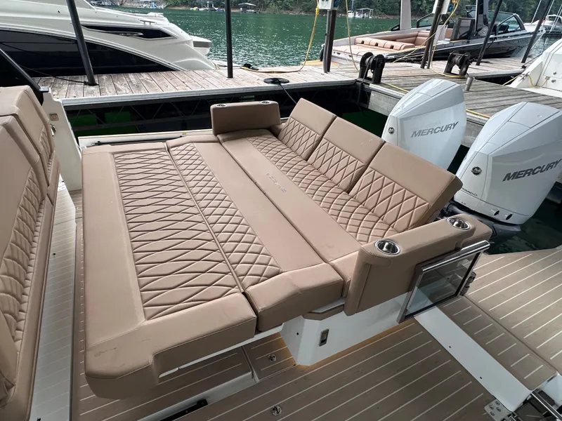 Slide: The Image of Saxdor 320 GTO 2027: Luxurious lounging area with beige cushions, surrounded by water and boats. - 20
