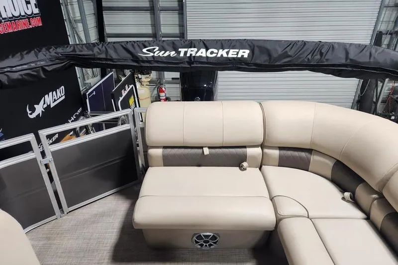 Slide: The Image of 2025 Sun Tracker Party Barge 20 DLX with beige seating and branded canopy. - 10