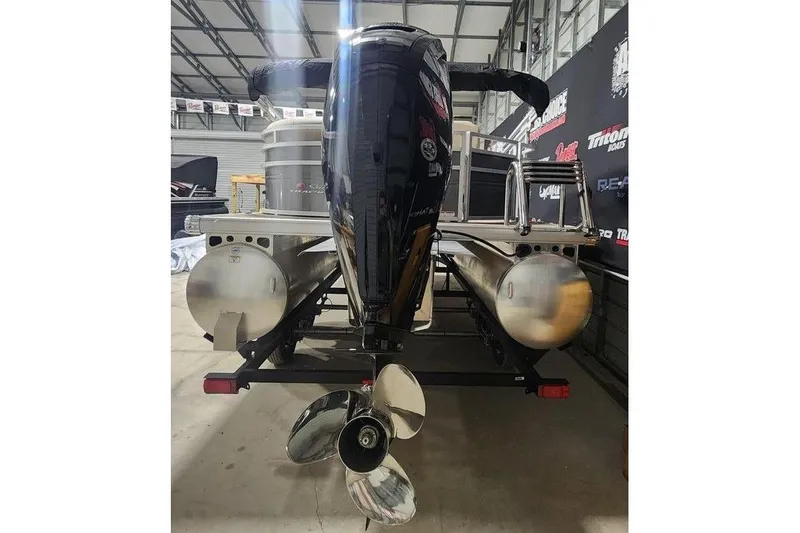 Slide: The Image of 2025 Sun Tracker Party Barge 20 DLX pontoon boat in a showroom, rear view. - 3