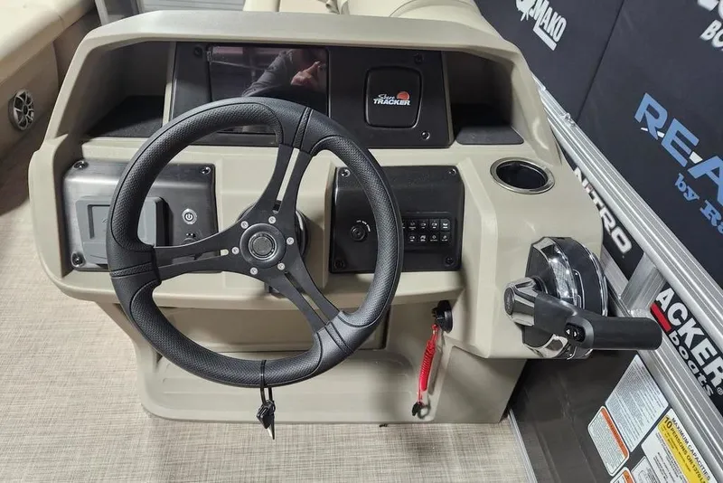 Slide: The Image of 2025 Sun Tracker Party Barge 20 DLX steering console with modern controls and sleek design. - 4