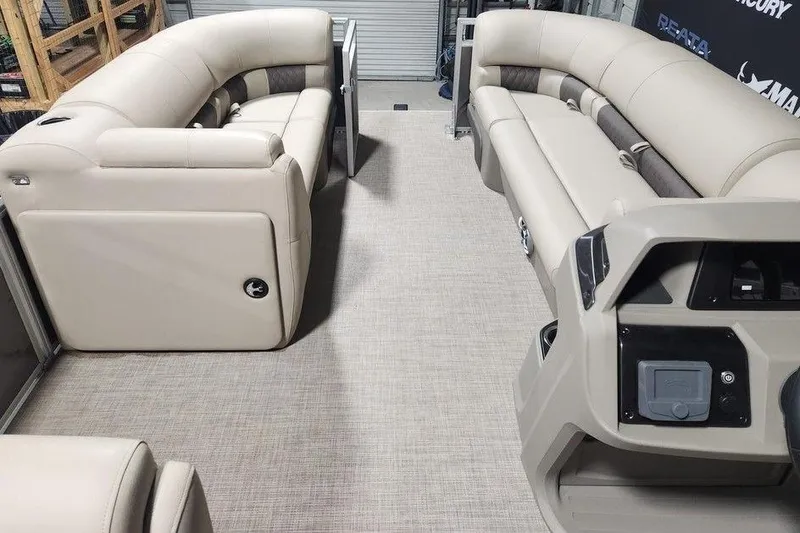 Slide: The Image of 2025 Sun Tracker Party Barge 20 DLX interior with beige seating and control panel. - 5