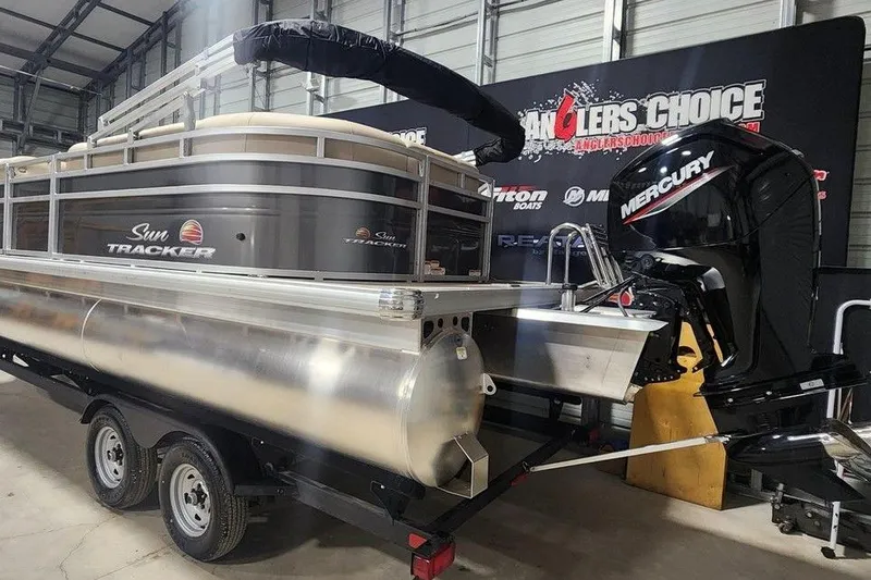 Slide: The Image of 2025 Sun Tracker Party Barge 20 DLX pontoon boat with Mercury engine in showroom. - 7