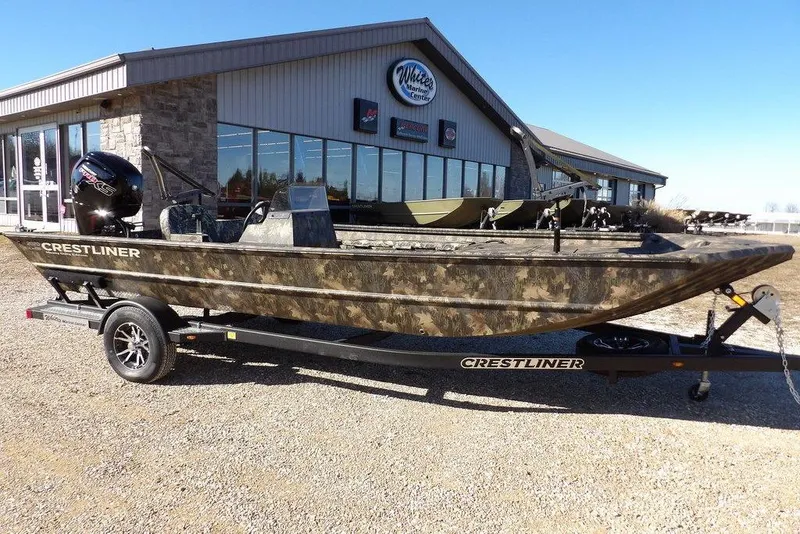 The Image of 2026 Crestliner 2070 Retriever SCHD boat on trailer outside dealership. - 1