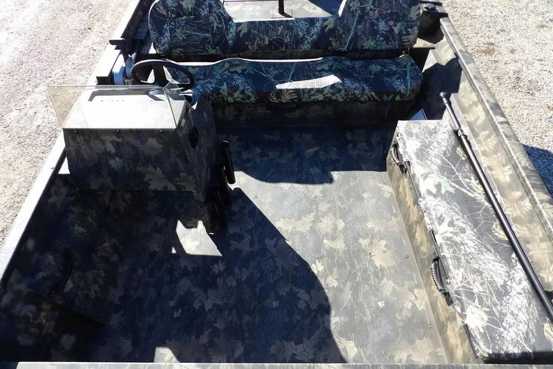 Slide: The Image of 2026 Crestliner 2070 Retriever SCHD boat interior with camouflage seating and steering console. - 12