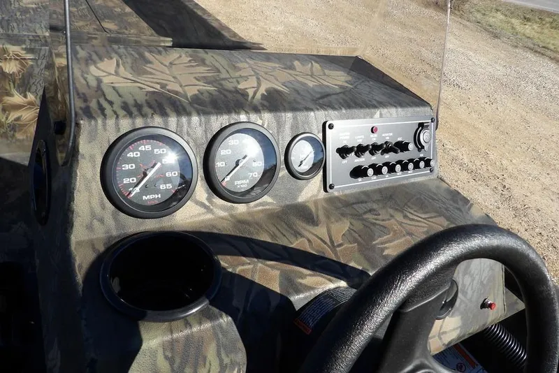 Slide: The Image of 2026 Crestliner 2070 Retriever SCHD dashboard with camouflage design and control panel. - 19