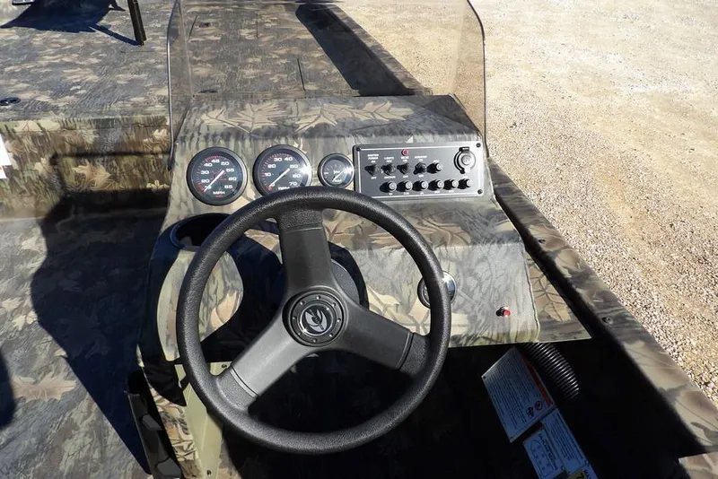 Slide: The Image of 2026 Crestliner 2070 Retriever SCHD boat dashboard with camouflage design and steering wheel. - 20