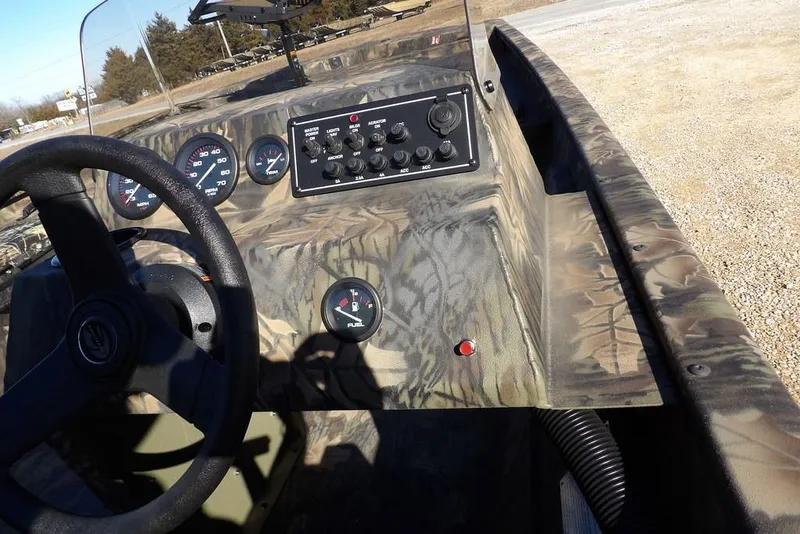 Slide: The Image of Interior of 2026 Crestliner 2070 Retriever SCHD boat with camouflage design and control panel. - 21