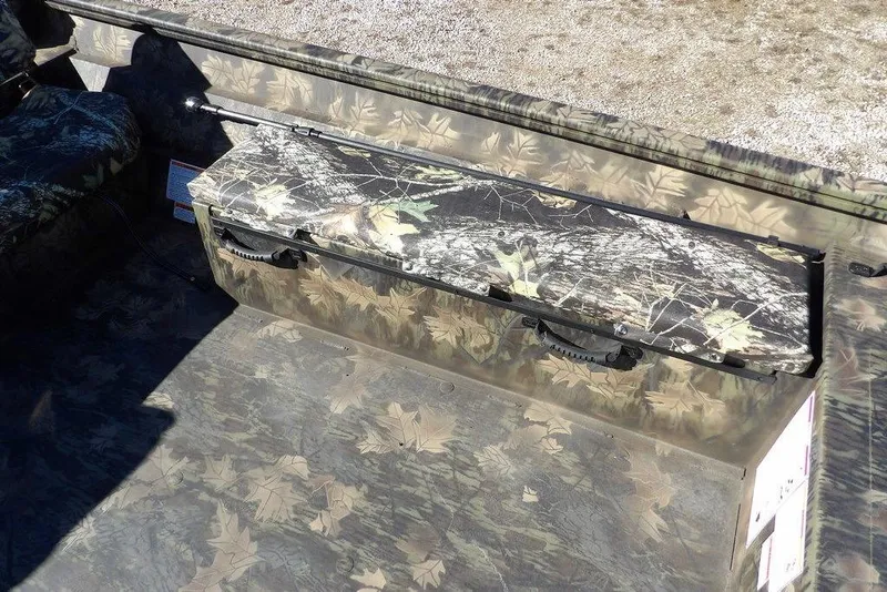 Slide: The Image of Crestliner 2070 Retriever SCHD 2026 boat interior with camouflage seating and storage. - 24