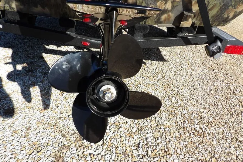 Slide: The Image of Propeller of 2026 Crestliner 2070 Retriever SCHD boat on gravel surface. - 31