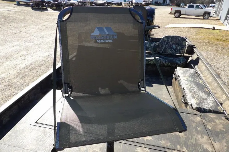 Slide: The Image of Crestliner 2070 Retriever SCHD boat with a mesh seat, parked outdoors. - 38