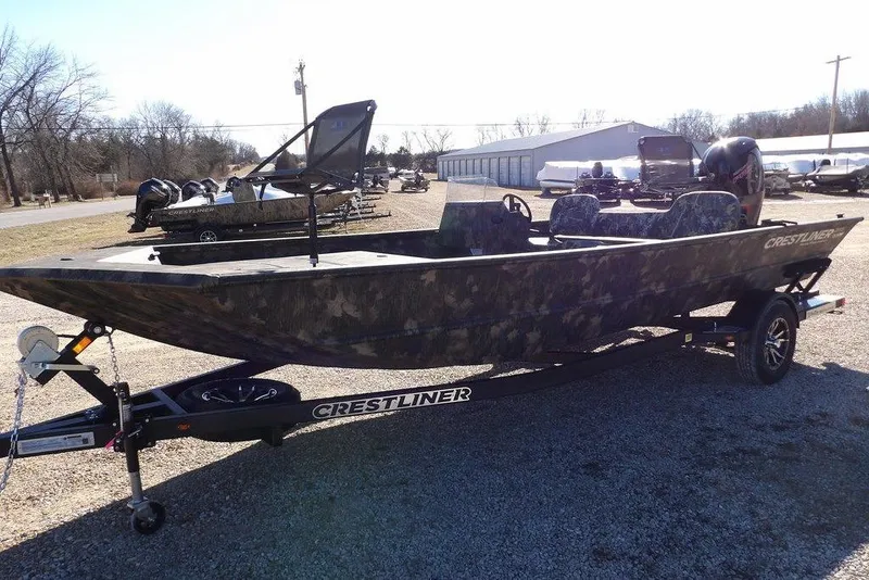 Slide: The Image of 2026 Crestliner 2070 Retriever SCHD boat on trailer, camo design, parked outdoors. - 4