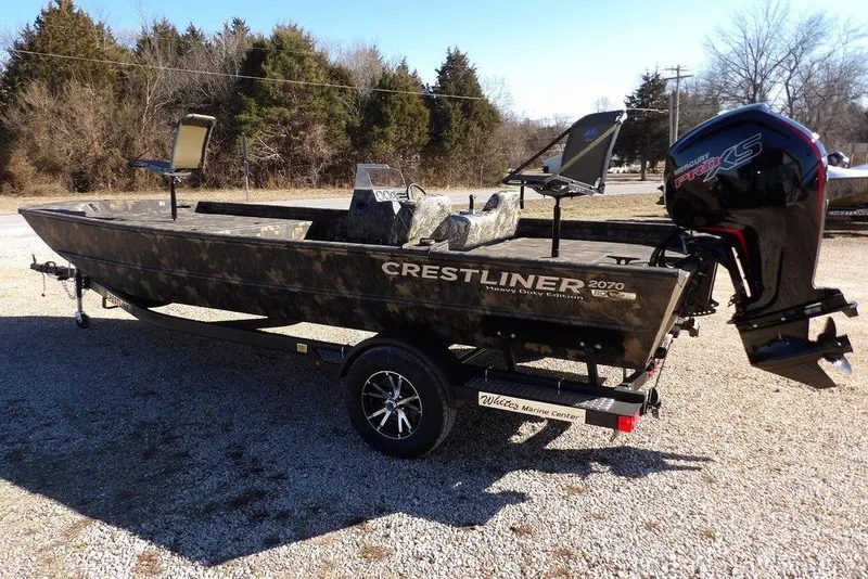 Slide: The Image of 2026 Crestliner 2070 Retriever SCHD boat with camo design and powerful outboard motor. - 8