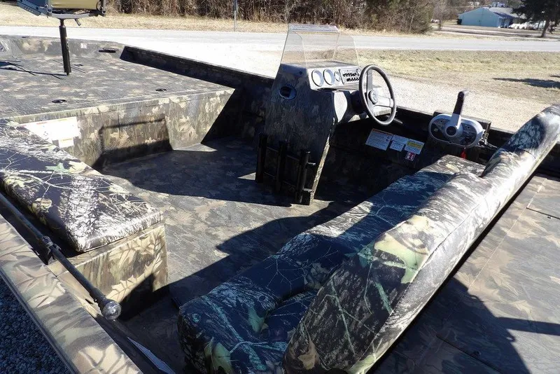 Slide: The Image of 2026 Crestliner 2070 Retriever SCHD boat interior with camouflage seating and steering console. - 9