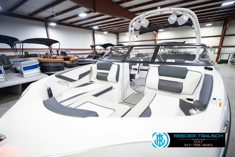 Slide: The Image of 2024 Yamaha Boats AR195 interior in showroom, featuring sleek seating and modern design. - 12