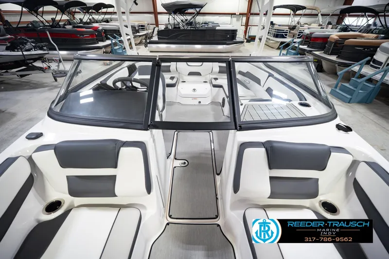 Slide: The Image of 2024 Yamaha Boats AR195 interior view in showroom, featuring sleek seating and modern design. - 19