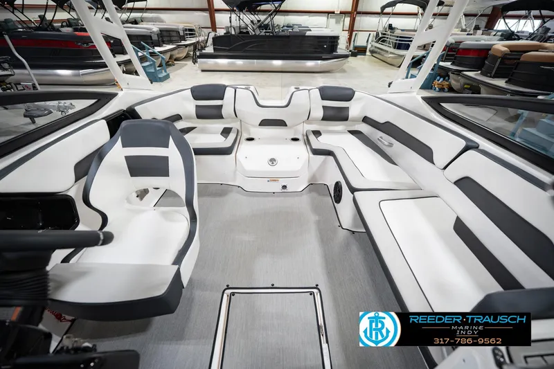 Slide: The Image of 2024 Yamaha Boats AR195 interior with sleek seating and modern design in showroom. - 20