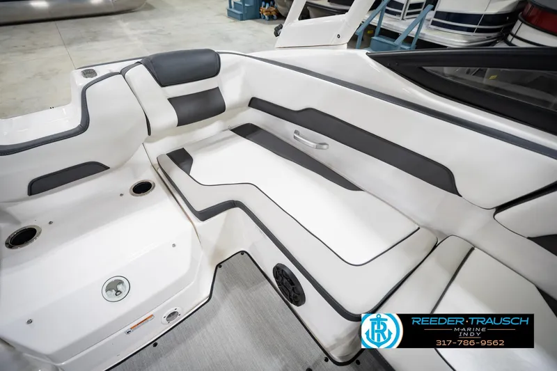 Slide: The Image of 2024 Yamaha Boats AR195 interior seating with sleek white and black design. - 22