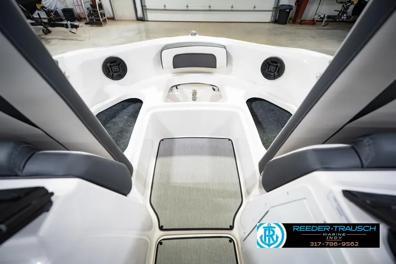 Slide: The Image of 2024 Yamaha Boats AR195 interior with seating and speakers, showcased in a showroom. - 25