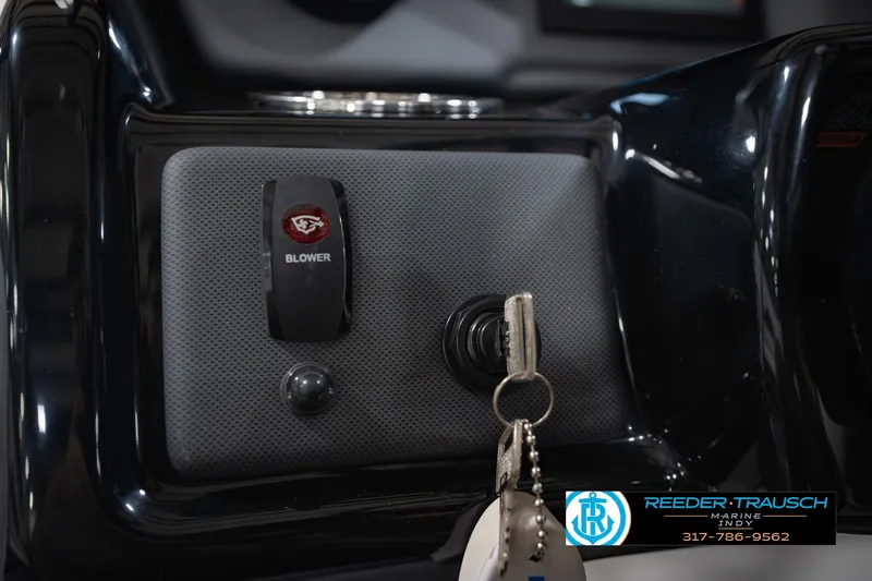 Slide: The Image of 2024 Yamaha AR195 boat dashboard with blower switch and ignition key. - 33