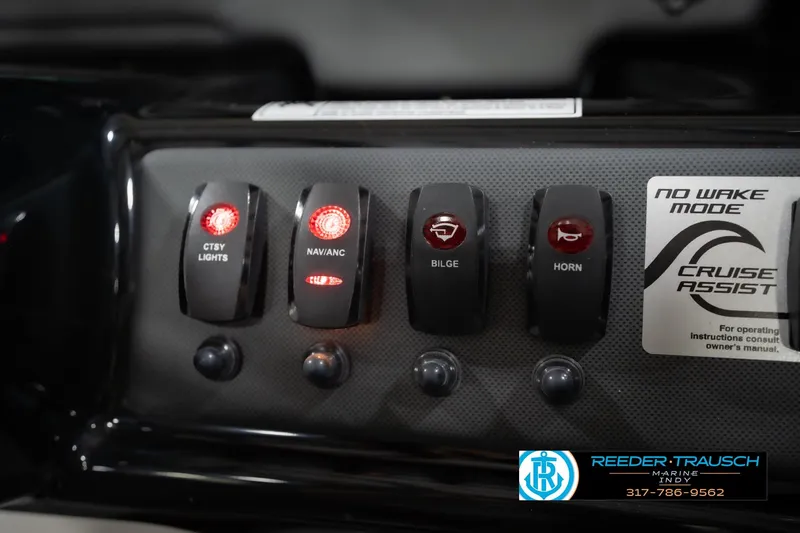 Slide: The Image of 2024 Yamaha AR195 boat control panel with lighted switches and cruise assist feature. - 36