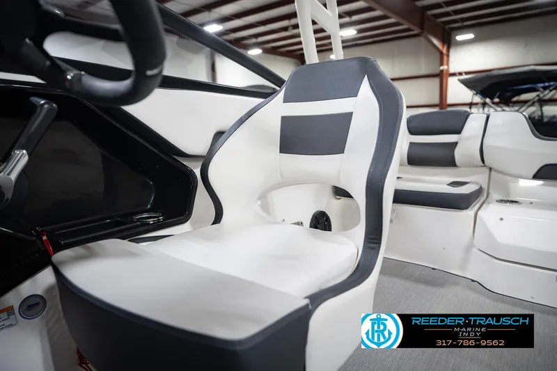 Slide: The Image of 2024 Yamaha AR195 boat interior with sleek, modern seating design in a showroom. - 38