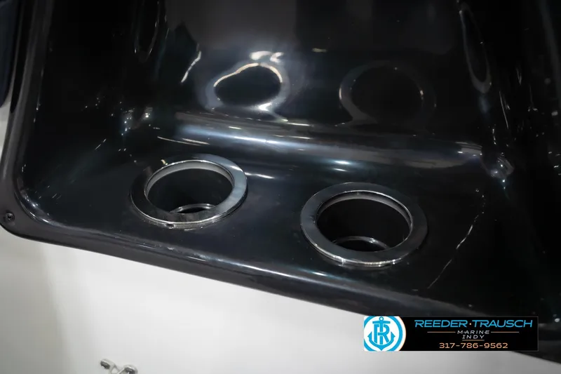 Slide: The Image of Cup holders in the 2024 Yamaha Boats AR195, featuring a sleek black interior design. - 44